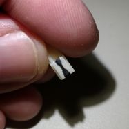 Side view of SKCM Ivory slider. Note the differences between the front (left) and rear bottom corners