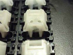 White two-eye click track slider with click arms omitted<ref name="Sandy-RT101-WL" />
