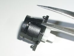 Opening the retention tab, after the legs are removed