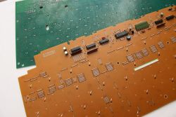 Underside view of PCBs from two keyboards: glass epoxy type (green), and paper phenol type (brown) used in older keyboards.