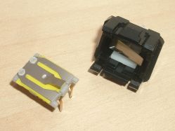Opened; unlike the patent image, the contact assembly is a flat discrete module