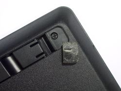 Stationary foot removed to reveal a hidden screw
