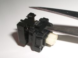 Insert thin implement and prise clip open