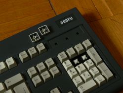 Detail of numpad showing raised Goupil logo, thick doubleshots, and M-shape sliders.