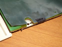 EM shield is secured with the grounding/earthing screw, and with electrical tape