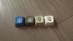 Keycap from an early Selectric typewriter (left), various beam spring keycaps (right)