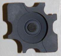 Bottom view of rubber dome, with black carbon contact pad in centre.