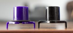 Switch sliders from a silenced switch (left) and a standard switch (right). Note the foam o-ring on the silenced variant. The silenced variant's longer stem counters the reduced travel from the foam o-ring. Not all silenced switches have this adjustment.