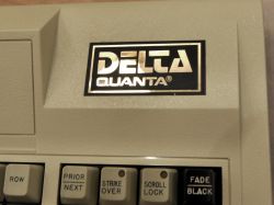 DELTA logo of Quanta Corporation in gold on black
