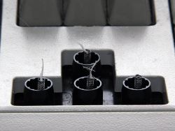 Three floss-modded switches (left) and one stock switch (right).
