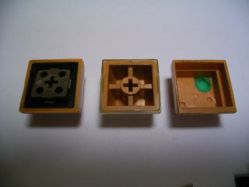 1st Generation keycaps; the rightmost keycap is actually from a Fujitsu vertical reed switch, the other two could possibly be from a 1st generation or vertical reed switch, as the keycaps are compatible.[Citation needed]