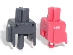 "Silent" Cherry MX slider designs, with upstroke and downstroke damping using a moulded-in rubber damper