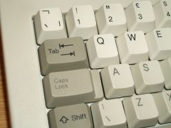 Double-shot vs laser-etched keycaps, depicting the reduced lettering contrast of traditional charring