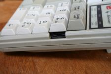 Hole in the case next to the '9' key on the numpad