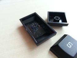Underside of keycaps. Notice the clear plastic stem on Caps Lock