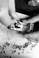 Switch assembly in the factory: actuator leaf spring is being fitted using a special jig