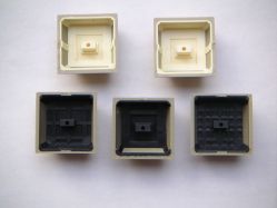 Assorted IBM 5556 keycaps, underside, showing the different moulding patterns
