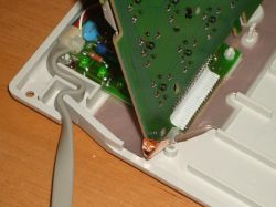 PCB is tethered by a ribbon cable and earthing strip