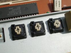 White tactile switches on mounting plate