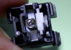 Top part of the case with slider, spring and lever