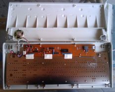 The case opened with the underside of the PCB and the beeper on the left