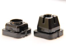 Switch housings from a standard Topre switch (left) and a Hi-Pro style keyboard (right) with sliders removed from both.