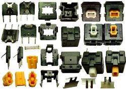 Partial disassembly of the switches from this keyboard; the white switch is used for space and enter