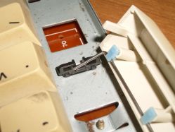 SMK stabilisers place the sliding action at the plate, instead of within the keycap insert; the plate insert also contains guide shafts to support guide posts in long keys (i.e. spacebar)