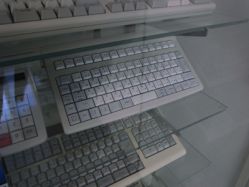 A Topre short-throw keyboard and possibly a short-throw calculator to the left.