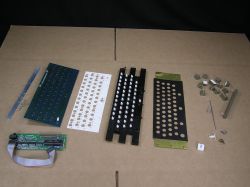 Components: strengthening bar, matrix and controller PCBs, insulating layer, array layer, top layer, and keycaps and other ancillary parts