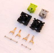 Disassembled linear and tactile switches; the long spring indicates a space bar switch