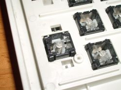 Case-mounted uppers; the switch uppers are open at the base to allow the switch to press on the membrane
